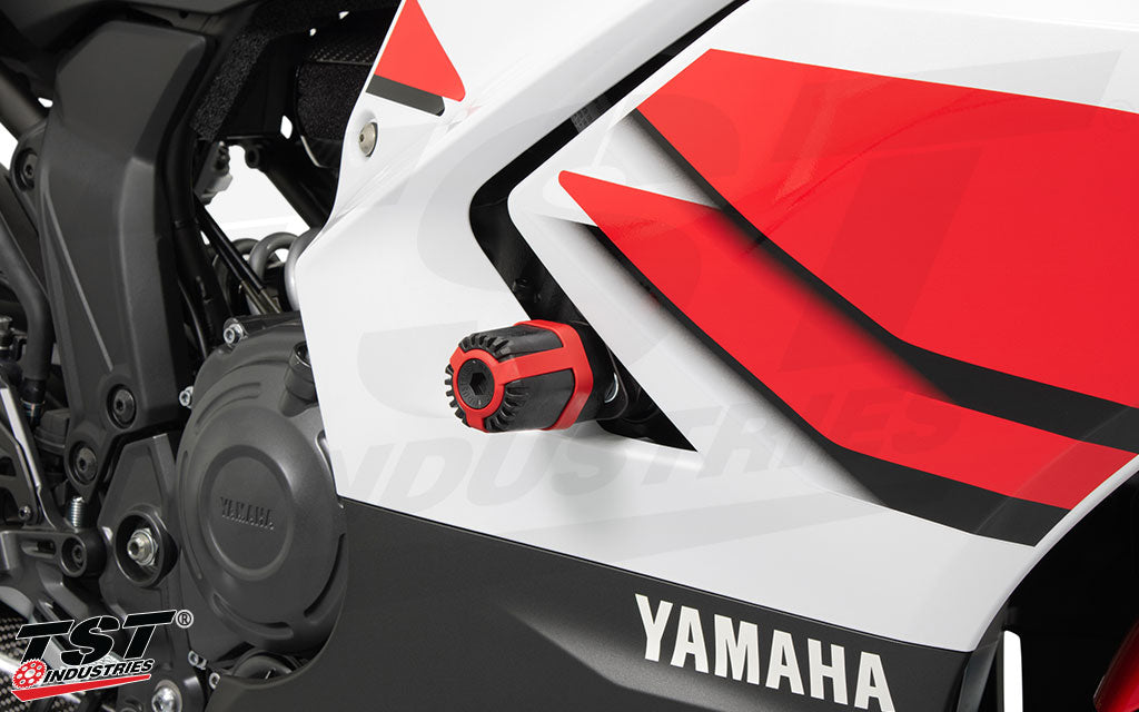 TST Industries Shock Absorbing Frame Sliders installed on the 2026 Yamaha YZF-R6 with red accent sleeve.