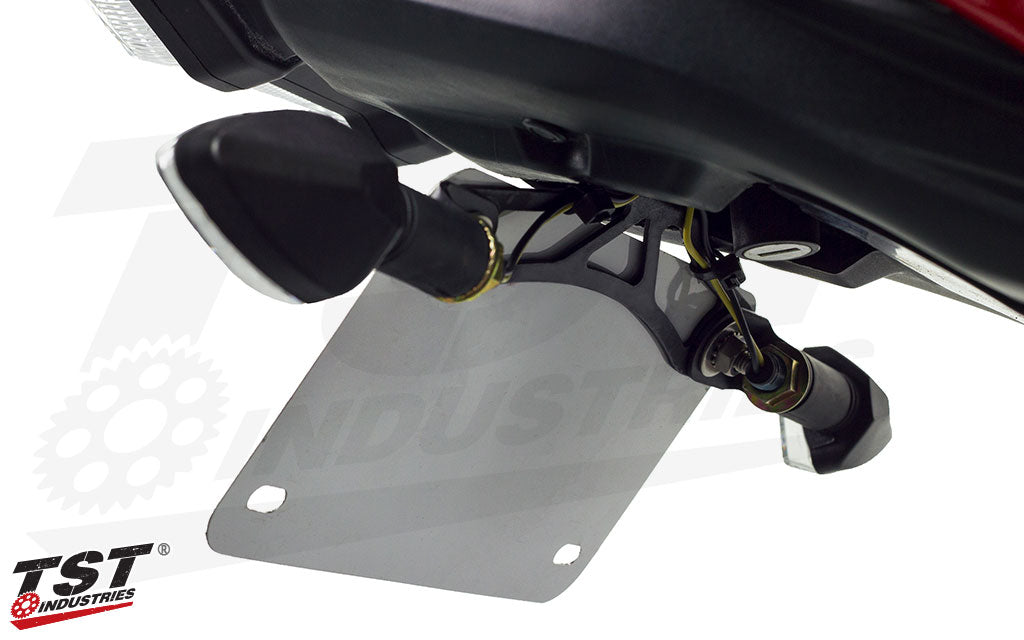 Mounts to the back of the license plate for easy installation of TST Pod Turn Signals and most aftermarket signals.