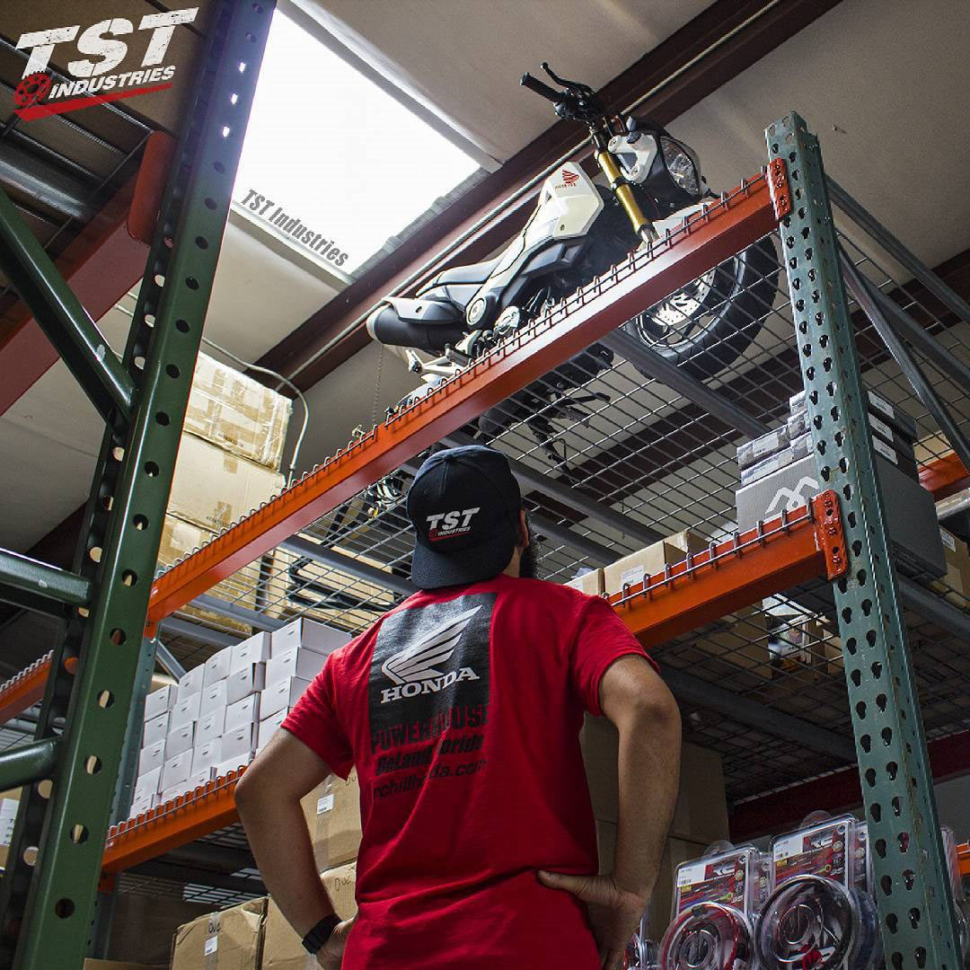 TST Industries crew pulling a prank by putting a Honda Grom on the top of a warehouse rack.