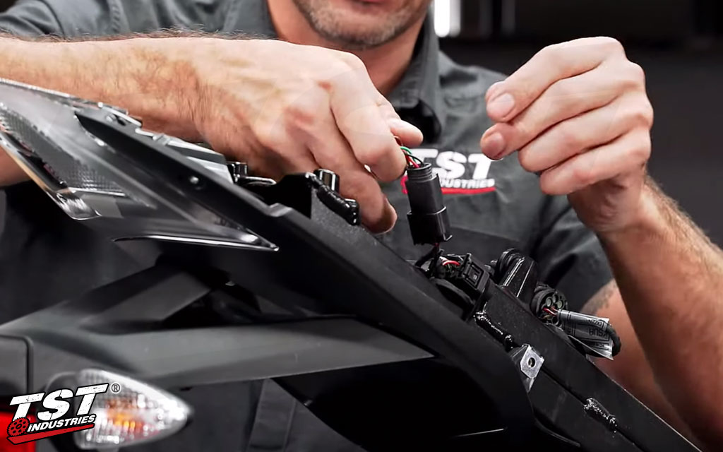 Bart showing the TST Male Plug Connector being installed on the BMW S1000RR.
