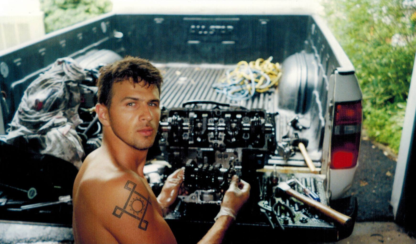 Founder of TST Industries, Bart Rogowski, working on a motorcycle engine when he was young.