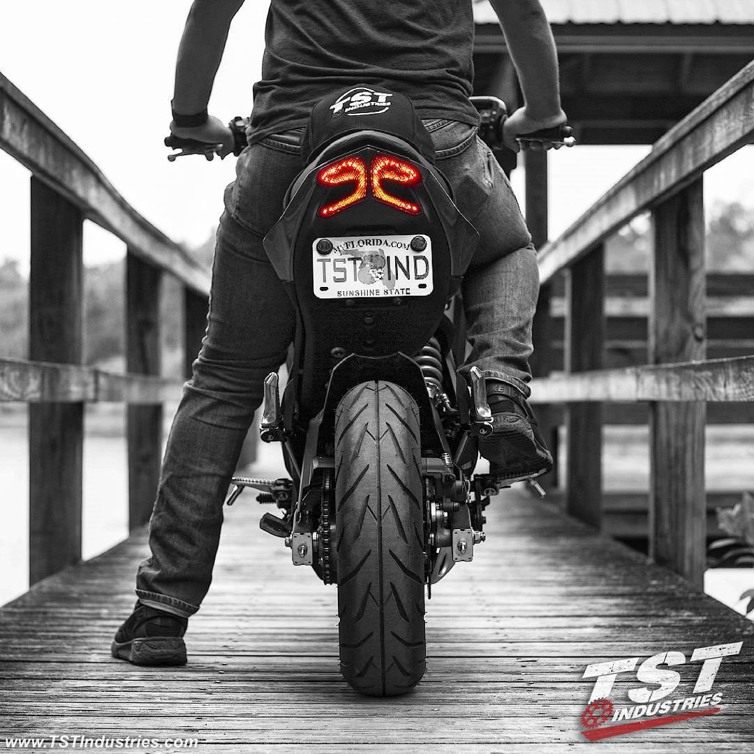 Kawasaki Z125 with TST Industries integrated tail light on a lake dock.