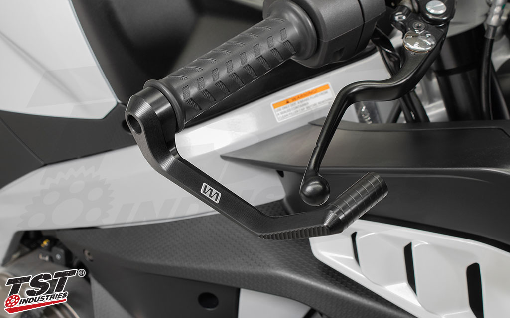 Black anodized brake lever guard shown installed on an Aprilia sportbike.